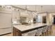 Modern kitchen featuring a large island, white cabinets, and stainless steel appliances at 14510 Leopard Creek Pl, Lakewood Ranch, FL 34202