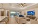Open-concept living room area featuring lots of seating and a television at 14510 Leopard Creek Pl, Lakewood Ranch, FL 34202