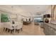 Open-concept living space with dining area, kitchen island, and comfortable seating at 14510 Leopard Creek Pl, Lakewood Ranch, FL 34202