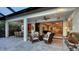 Relaxing outdoor space with seating, BBQ, and views of the living room through sliding glass doors at 14510 Leopard Creek Pl, Lakewood Ranch, FL 34202