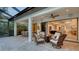 Relaxing patio with a fire pit, wicker furniture, an outdoor kitchen, and open access to the home at 14510 Leopard Creek Pl, Lakewood Ranch, FL 34202