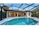 Outdoor entertaining with a screened pool, dining, and an open-concept connection to indoor spaces at 14510 Leopard Creek Pl, Lakewood Ranch, FL 34202