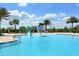 Community pool with splash features, colorful play structures, and plenty of room for children to enjoy at 14510 Leopard Creek Pl, Lakewood Ranch, FL 34202