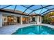 Backyard with a screened pool, outdoor seating, dining area, and open layout for entertaining at 14510 Leopard Creek Pl, Lakewood Ranch, FL 34202