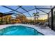 Screened-in pool area featuring a glistening pool, lounge chairs, and a dining set at 14510 Leopard Creek Pl, Lakewood Ranch, FL 34202