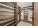 Spacious walk-in closet with custom shelving and ample storage space at 14510 Leopard Creek Pl, Lakewood Ranch, FL 34202