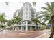 Elegant exterior showcases architectural details, with lush palm trees enhancing its appeal at 1500 State St # 305, Sarasota, FL 34236