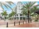 Beautiful exterior view of the building, complemented by palm trees and a welcoming street view at 1500 State St # 305, Sarasota, FL 34236