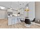 A modern kitchen adjacent to dining area with stylish barstool seating and stainless appliances at 1500 State St # 305, Sarasota, FL 34236