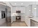 Bright kitchen with stainless steel appliances and white cabinets with wood style flooring throughout at 1500 State St # 305, Sarasota, FL 34236