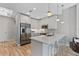 Well-lit modern kitchen with sleek white cabinetry, stainless steel appliances, and breakfast bar at 1500 State St # 305, Sarasota, FL 34236