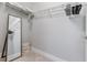 Bright walk-in closet features white wire shelving, mirror, and neutral carpeting at 1500 State St # 305, Sarasota, FL 34236