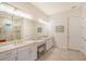 Bright bathroom with double vanity, granite countertops, and tiled shower at 15115 Montello Way, Lakewood Ranch, FL 34211