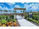 A welcoming community garden with colorful flowers and lush greenery, offering a serene outdoor space at 15115 Montello Way, Lakewood Ranch, FL 34211