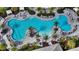 Zero-entry community pool surrounded by lounge chairs, palm trees, and umbrellas at 15115 Montello Way, Lakewood Ranch, FL 34211