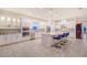 Modern kitchen featuring white cabinetry, stainless steel appliances, tiled backsplash, and large island with seating at 15115 Montello Way, Lakewood Ranch, FL 34211