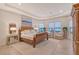 Serene main bedroom suite with tray ceilings, water views, and sophisticated decor at 15115 Montello Way, Lakewood Ranch, FL 34211