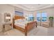 Elegant main bedroom suite with tray ceilings, water views, and sophisticated decor at 15115 Montello Way, Lakewood Ranch, FL 34211