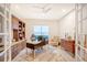 Elegant home office with custom built-ins, a large desk, and comfortable seating at 15115 Montello Way, Lakewood Ranch, FL 34211