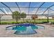 Private pool with brick patio, surrounded by lush landscaping and a serene lake view at 15115 Montello Way, Lakewood Ranch, FL 34211