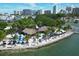 Aerial view of a tropical waterfront restaurant with beach seating and city skyline at 1771 Ringling Blvd # 703, Sarasota, FL 34236