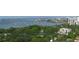Scenic aerial view of waterfront community with lush trees and distant city skyline at 1771 Ringling Blvd # 703, Sarasota, FL 34236