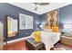 Comfortable bedroom features stylish decor, shuttered window, wooden floors and a unique accent wall hanging at 1771 Ringling Blvd # 703, Sarasota, FL 34236