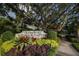Marie Selby Botanical Gardens sign surrounded by vibrant, colorful landscaping and foliage at 1771 Ringling Blvd # 703, Sarasota, FL 34236