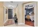 Inviting hallway with tile flooring leading to a bedroom with ceiling fan at 1771 Ringling Blvd # 703, Sarasota, FL 34236
