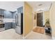 Modern kitchen adjacent to the entry featuring stainless steel appliances and tile floors at 1771 Ringling Blvd # 703, Sarasota, FL 34236
