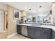 Modern kitchen features stainless steel appliances, gray cabinets, and decorative backsplash at 1771 Ringling Blvd # 703, Sarasota, FL 34236