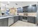 Beautiful open kitchen with stainless steel appliances and quartz countertop, open to living area at 1771 Ringling Blvd # 703, Sarasota, FL 34236
