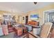 Spacious living room with hardwood floors open to kitchen, modern decor and large TV at 1771 Ringling Blvd # 703, Sarasota, FL 34236