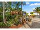 Tropical outdoor bar with thatched roof surrounded by lush foliage, seating, and a waterfront view at 1771 Ringling Blvd # 703, Sarasota, FL 34236
