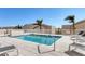 Beautiful outdoor pool with lounge chairs on the tile deck and lush landscaping at 1771 Ringling Blvd # 703, Sarasota, FL 34236