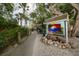 Colorful sign leading to a waterfront restaurant with tropical foliage at 1771 Ringling Blvd # 703, Sarasota, FL 34236