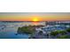 Panoramic aerial view of the waterfront at sunset with boats, bridge and vibrant city skyline at 211 Cosmopolitan Ct # 211, Sarasota, FL 34236