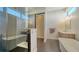Bright bathroom featuring double vanity, soaking tub, walk-in shower, and modern fixtures at 211 Cosmopolitan Ct # 211, Sarasota, FL 34236