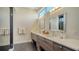 Modern bathroom featuring double sinks, sleek cabinetry, a walk-in shower with glass door, and natural light at 211 Cosmopolitan Ct # 211, Sarasota, FL 34236