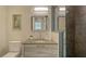 Cozy bathroom with modern fixtures, a framed mirror, a glass shower, and an open vanity at 211 Cosmopolitan Ct # 211, Sarasota, FL 34236