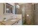 A modern bathroom boasts a stylish vanity, sleek fixtures, and a frameless glass shower for a luxurious feel at 211 Cosmopolitan Ct # 211, Sarasota, FL 34236