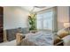 Bright bedroom features a ceiling fan, stylish dresser, and natural lighting at 211 Cosmopolitan Ct # 211, Sarasota, FL 34236