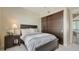 Comfortable bedroom features a sliding closet, accent lamps, and neutral tones for a relaxing retreat at 211 Cosmopolitan Ct # 211, Sarasota, FL 34236