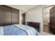 Well-lit bedroom with a sliding door closet, and a blue duvet covered bed with a knitted throw blanket at 211 Cosmopolitan Ct # 211, Sarasota, FL 34236