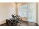 Bonus room with two racing bikes parked on hardwood floors next to a bench and window with coverings at 211 Cosmopolitan Ct # 211, Sarasota, FL 34236