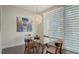 Well-lit dining area with a glass table, wooden chairs, and elegant lighting at 211 Cosmopolitan Ct # 211, Sarasota, FL 34236