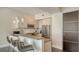Modern kitchen with stainless steel appliances, breakfast bar, and stylish pendant lights at 211 Cosmopolitan Ct # 211, Sarasota, FL 34236