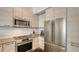 Bright kitchen with stainless appliances and light wood cabinetry at 211 Cosmopolitan Ct # 211, Sarasota, FL 34236