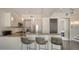 Modern kitchen with stainless steel appliances, breakfast bar, and stylish pendant lights at 211 Cosmopolitan Ct # 211, Sarasota, FL 34236