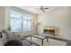 Relaxing living room with large window, comfortable sofa, and a modern glass coffee table at 211 Cosmopolitan Ct # 211, Sarasota, FL 34236